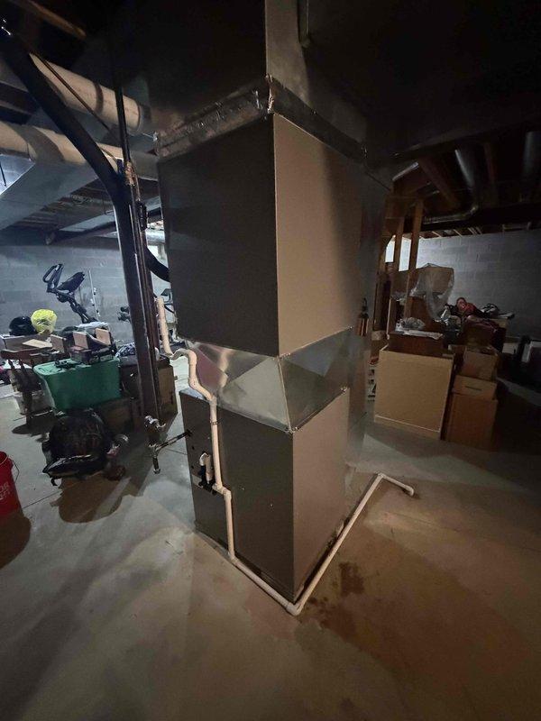 Installed a new Lennox 90%+ high-efficiency gas furnace in the basement, connecting it to the existing galvanized supply plenum and ductwork with a sealed transition. Piped the PVC intake and exhaust venting, routed the condensate drain line to the floor drain, and reconnected the gas supply with black iron piping and fittings. Completed electrical connections and verified proper startup, combustion, and operation.