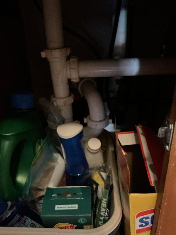 Assessed the kitchen drain line following a prior contractor's recommendation for a floor break-up, inspecting the under-sink PVC drain assembly and P-trap for signs of failure or blockage. Findings did not support the need for floor excavation, and the drain line was addressed to restore proper flow through the kitchen sink drain.