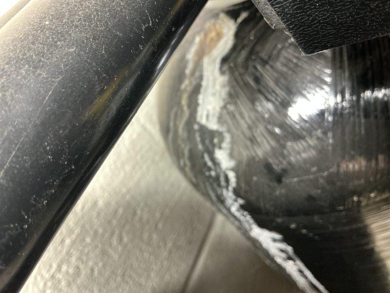 Responded to a leak at the Nelson air injection filter system installed in 2021. Inspection revealed mineral and salt deposit buildup with active seepage along the dome and side of the fiberglass-wrapped pressure tank near the control valve connection. Documented the affected tank and fittings with photos to support evaluation of the tank and valve connection for repair or replacement.