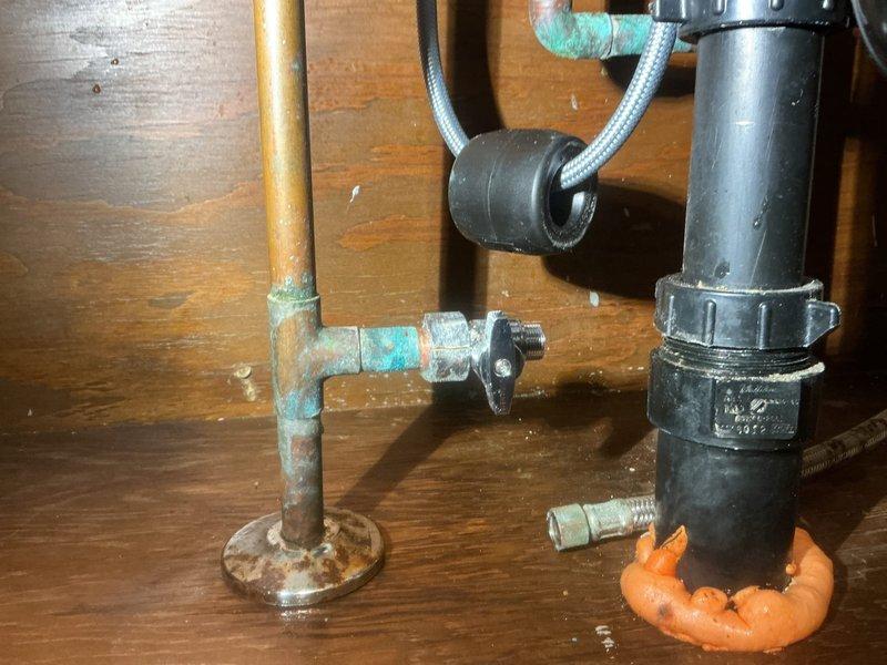 Replaced the kitchen faucet with a new Moen pull-out spray faucet and installed a new soap dispenser. Replaced the corroded cold water and dishwasher straight stop valves, leaving the dishwasher supply line disconnected for the pending appliance replacement.
