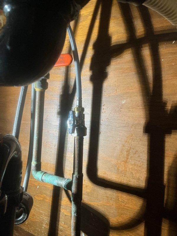 Replaced the kitchen faucet with a new Moen pull-out spray faucet and installed a new soap dispenser. Replaced the corroded cold water and dishwasher straight stop valves, leaving the dishwasher supply line disconnected for the pending appliance replacement.