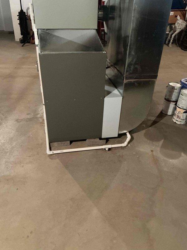Performed annual preventive maintenance tune-up on a gas-fired, condensing furnace with a functioning system. Inspected the cabinet, supply plenum, ductwork, flue venting, and PVC condensate drain and pump assembly, and verified electrical connections at the junction box. No frost, corrosion, or visible damage was observed, and the unit was left operating properly.