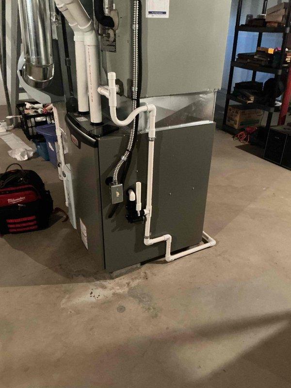 Performed annual preventive maintenance tune-up on a gas-fired, condensing furnace with a functioning system. Inspected the cabinet, supply plenum, ductwork, flue venting, and PVC condensate drain and pump assembly, and verified electrical connections at the junction box. No frost, corrosion, or visible damage was observed, and the unit was left operating properly.