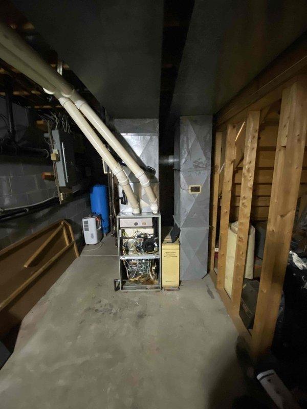 Performed assessment of propane HVAC system following lead from Jeff. Inspection revealed aging unit with exposed internal components and wiring requiring replacement. Examined existing ventilation infrastructure including PVC pipes and ductwork connections. Evaluated plumbing integration with current system to determine appropriate specifications for replacement unit.