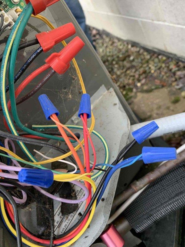 Diagnosed system that was continuously running in auxiliary heat mode despite moderate outdoor temperatures, causing excessive energy consumption (65W auxiliary heat). Inspected thermostat wiring connections and verified proper heat pump/conventional system configuration. Rewired connections at both the outdoor unit and thermostat terminal blocks to restore proper staging sequence, ensuring the system now operates in standard heat pump mode during appropriate temperature conditions.