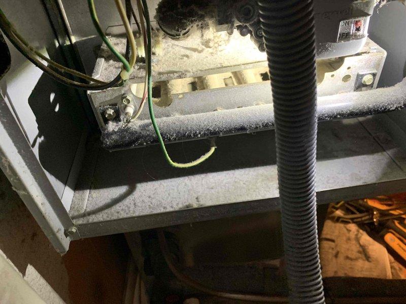 Performed routine 2-year heating maintenance on member's system. Discovered significant ice buildup on evaporator coil indicating possible refrigerant restriction or airflow issues. Used hex key tool to access components for proper inspection and servicing.
