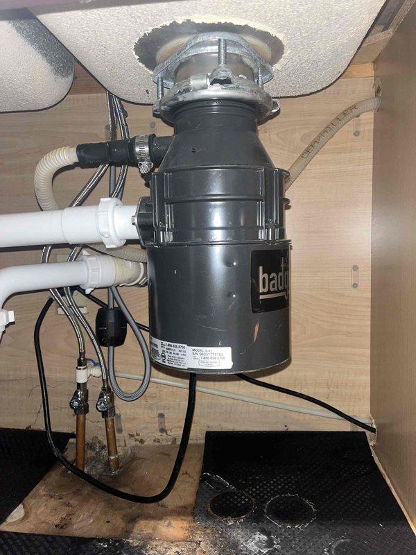 Responded to call for blocked garbage disposal issue. Upon arrival, inspected the Badger unit installed under kitchen sink. Cleared obstruction and tested drainage by running water through stainless steel sink basin. Unit now functioning properly with normal water flow.