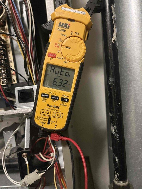 Performed comprehensive tune-up on furnace air handler including combustion analysis testing with readings of 310.8°F stack temperature, 8.4% O2, and 37/62 PPM CO levels. Electrical system inspection conducted using clamp meter verified 6.32V at terminals, ensuring proper voltage supply to components. System operating at 66.9% efficiency with 82.2°F temperature differential.