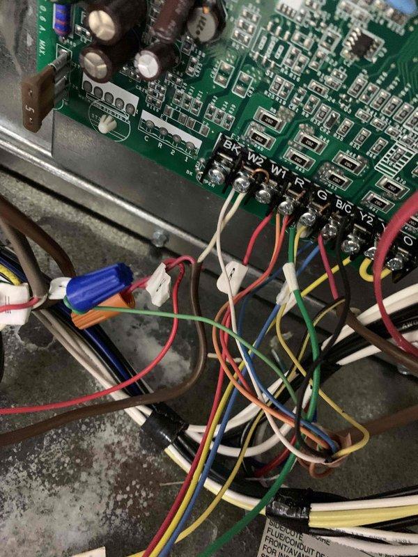 Responded to service call regarding a malfunctioning HVAC system that was continuously running and overheating the residence to 84°F despite thermostat setting of 71°F. Upon inspection of the control board, found incorrect thermostat wire connections at the terminal strip which were causing system to run continuously. Rewired connections properly according to manufacturer specifications and verified proper system operation with temperature returning to setpoint.