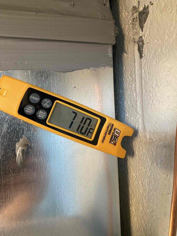 Completed installation of a complete HVAC system as a return job sold by Greg and flipped by Sam Kdz. System includes new furnace, ductwork, and connections to existing 100-gallon Smith water heater. Post-installation temperature verification confirmed proper operation with supply air temperature at 71.0°F.