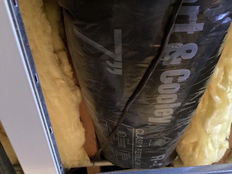 Installed new ductwork to supply HVAC service to second floor room. Work included positioning and securing black R-8 insulated cylindrical duct with proper connections to existing system. Completed installation with fiberglass insulation around ductwork to ensure optimal thermal efficiency.