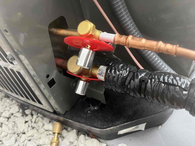 Completed installation of new HVAC system with control board wiring connections properly secured and color-coded (red, white, blue, green, yellow). Installed copper refrigerant lines with proper insulation and shutoff valve, and set up collection tray for condensate drainage. Water heater was left in original packaging per customer request from sale by Greg.