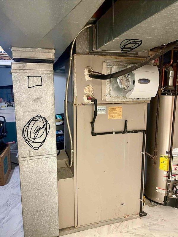Installed and wired customer-supplied humidistat to existing Heatcoil furnace system with side-mounted humidifier unit. Completed all necessary electrical connections using flexible metal conduit, ensuring proper integration with the HVAC control system for optimal humidity regulation.