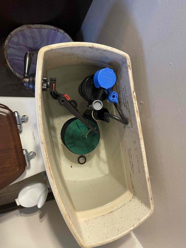 Diagnosed and repaired a leaking toilet by inspecting both the water supply line connection and internal tank components. Identified mineral buildup and wear on the flush valve assembly contributing to the leak. Serviced the internal mechanisms and secured all connections to resolve the issue.