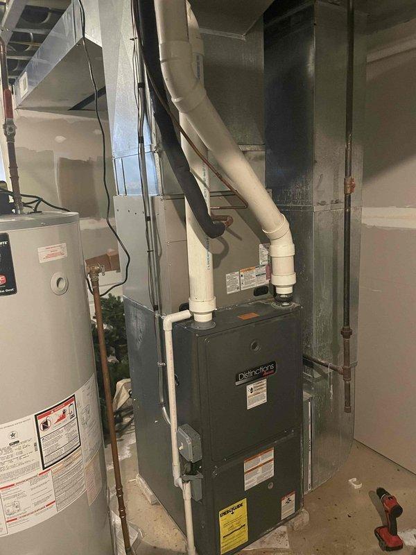 Responded to no heat complaint for aging Distinction furnace. Inspection revealed extensive corrosion and rust on heat exchanger, indicating critical safety hazard. Condemned unit due to cracked heat exchanger which was allowing combustion gases to mix with supply air. Recommended complete system replacement as repair not economically viable for equipment of this age.