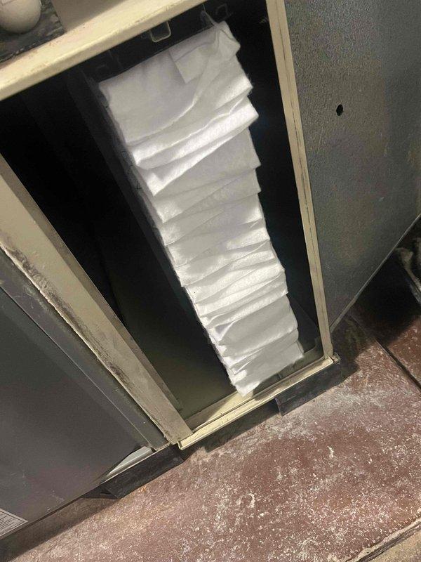 Responded to callback after steam humidifier installation where customer reported inadequate heating (system set at 70° but only reaching 65°). Upon inspection, discovered severely clogged air filter restricting proper airflow. Replaced filter and verified system operation, restoring normal heating function.