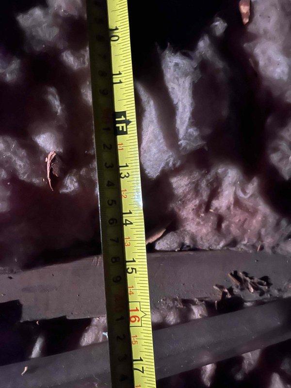 Conducted site assessment for HVAC system replacement at property currently utilizing boiler baseboard heating without air conditioning. Evaluated unfinished basement for potential furnace/AC installation. Documented existing utility connections and measured insulation thickness (approximately 10-17 inches) to determine appropriate system specifications for dual-zone implementation.