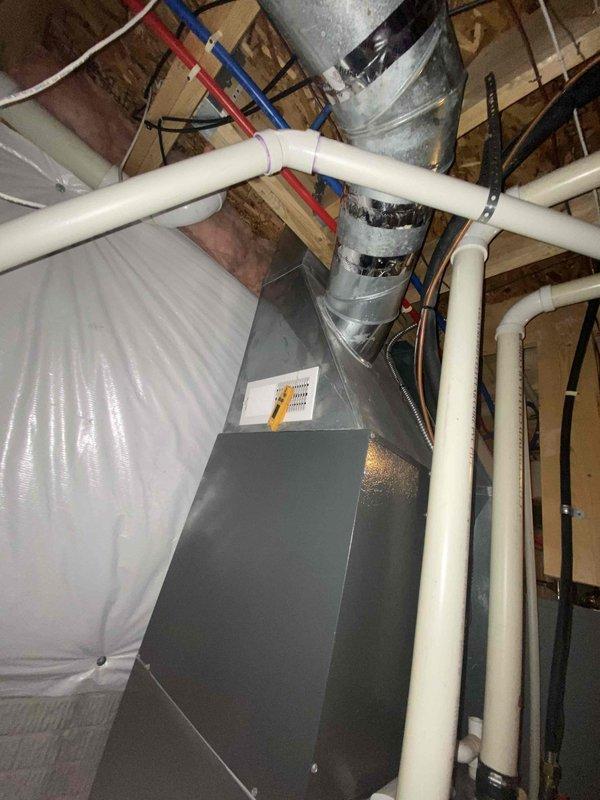 Conducted estimate for furnace replacement in residential basement. Current system includes metal HVAC unit with connected ductwork and PVC ventilation lines. Evaluation included assessment of existing installation, ductwork condition, and available utility connections in the unfinished basement space.