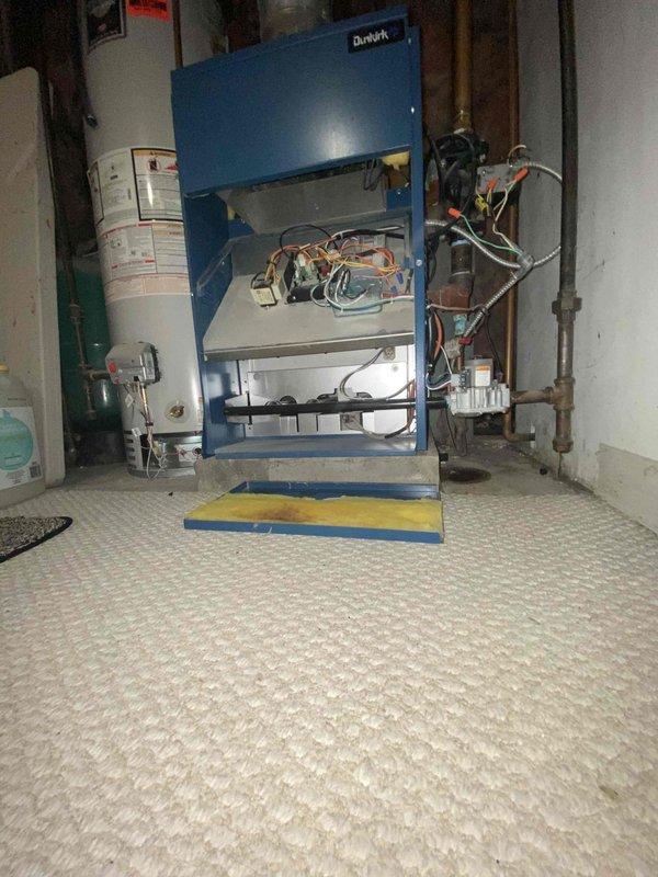 Performed comprehensive diagnostic assessment of Dunkirk boiler system with cabinet open to examine internal electrical components and control wiring. Thermostat reading showed 42 degrees, indicating potential system failure or improper operation requiring further evaluation and possible replacement components.