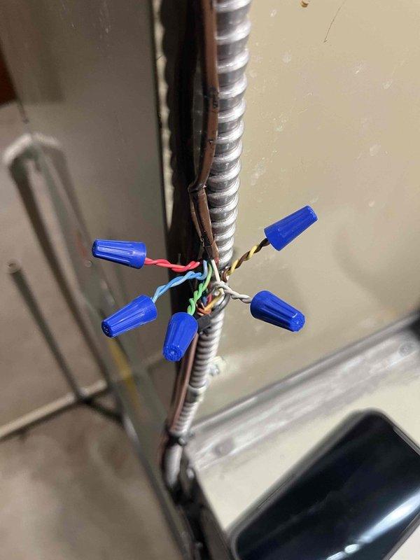 Responded to callback for non-functioning fan in manual mode on 65W air handler. Diagnosed issue with electronic control board showing "EOF" error code on display. Inspected and corrected electrical connections, focusing on the wire connections at junction points. System now functioning properly in all modes.
