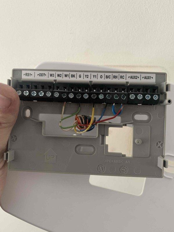 Responded to service call for furnace system with short cycling issue. Inspected thermostat wiring connections at terminal strip and verified proper operation. System is maintaining temperature despite frequent cycling. Confirmed air handler drawing 65 watts during operation.