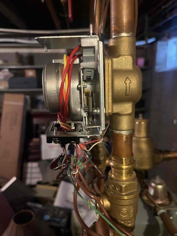 Responded to service call for zone valve replacement. Upon inspection of the heating system, identified a faulty zone valve actuator with visible wear on the internal components. Successfully replaced the defective zone valve on the copper supply line, ensuring proper flow direction as indicated by the directional arrows on the valve body.