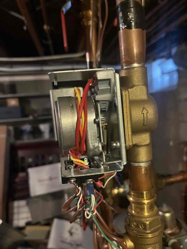 Responded to service call for zone valve replacement. Upon inspection of the heating system, identified a faulty zone valve actuator with visible wear on the internal components. Successfully replaced the defective zone valve on the copper supply line, ensuring proper flow direction as indicated by the directional arrows on the valve body.