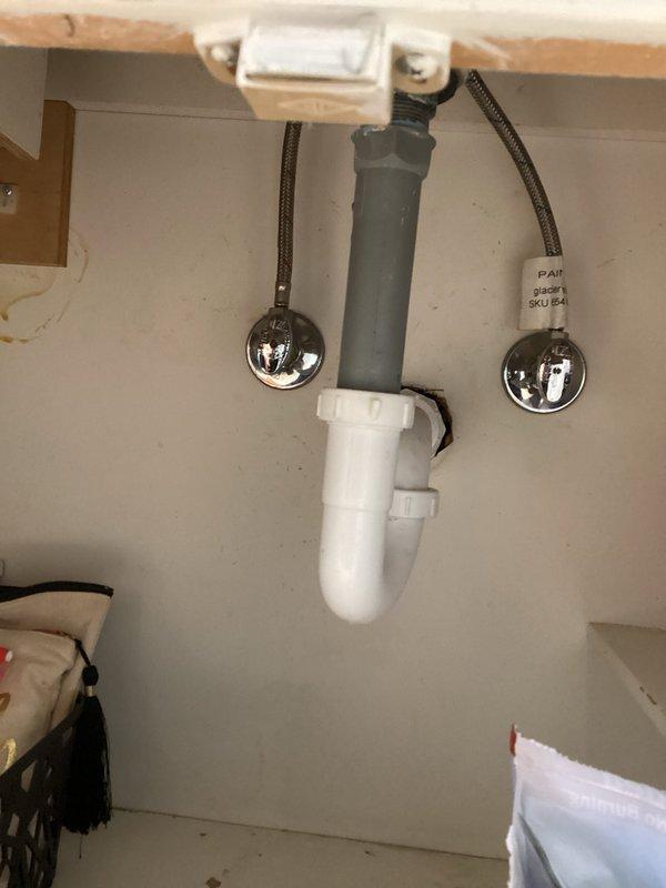 Completed scheduled plumbing membership visit, inspecting bathroom fixtures including bathtub/shower assembly and under-sink plumbing. Performed visual examination of P-trap assembly, water supply lines, and shut-off valves under sink, noting minor water staining on wall surface. All components found to be in proper working order with no immediate maintenance concerns.
