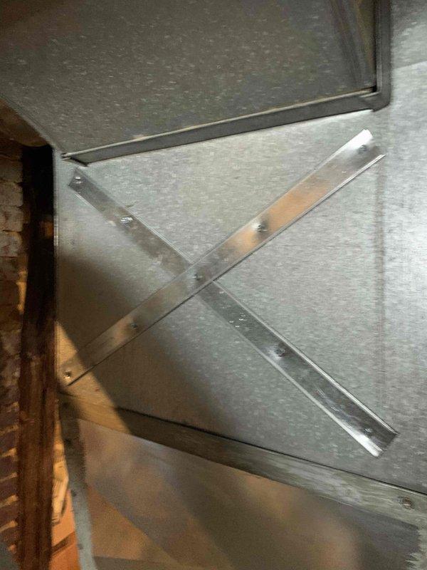 Responded to callback for noise complaint - customer reported "thunk" sound when furnace cycles off. Inspection revealed inadequate ductwork reinforcement causing metal expansion/contraction noise. Installed X-bracing on sheet metal panels and verified proper test port cover placement to eliminate the noise issue.