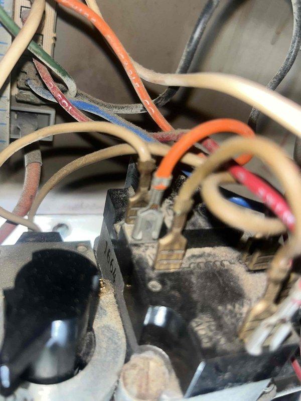 Diagnosed furnace malfunction by inspecting internal electrical components. Found loose and corroded wire connections at terminal block. Cleaned connection points and secured all wiring to restore proper electrical flow, successfully returning unit to normal operation.