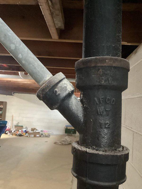 Responded to sump pump alarm activation. Inspected the system in basement, including the cast iron drainage pipes and sump pit. Found moisture around the sump basin indicating proper pump activation. Verified electrical connections and discharge pipe functionality to ensure system operating correctly.