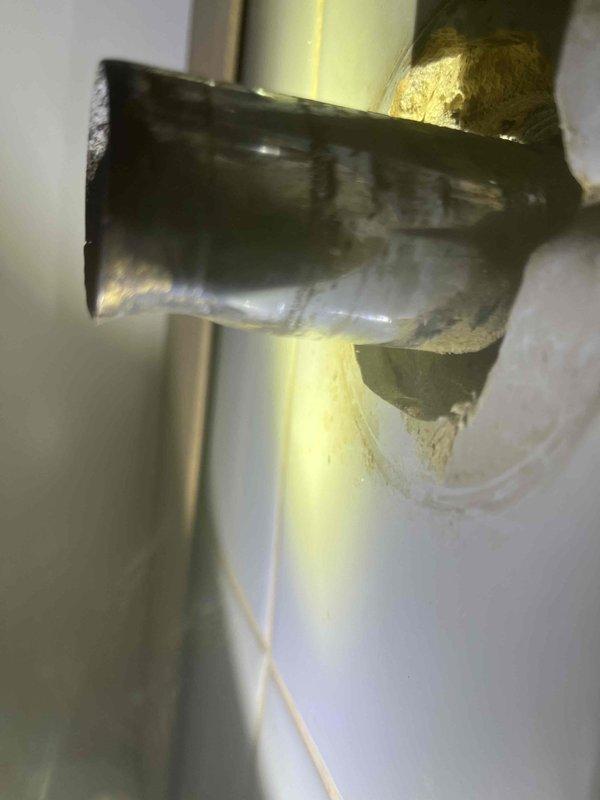 Replaced leaking P-trap in upstairs bathroom. Identified corrosion and water damage around pipe connection to wall. Installation completed with new P-trap to resolve the leak issue.