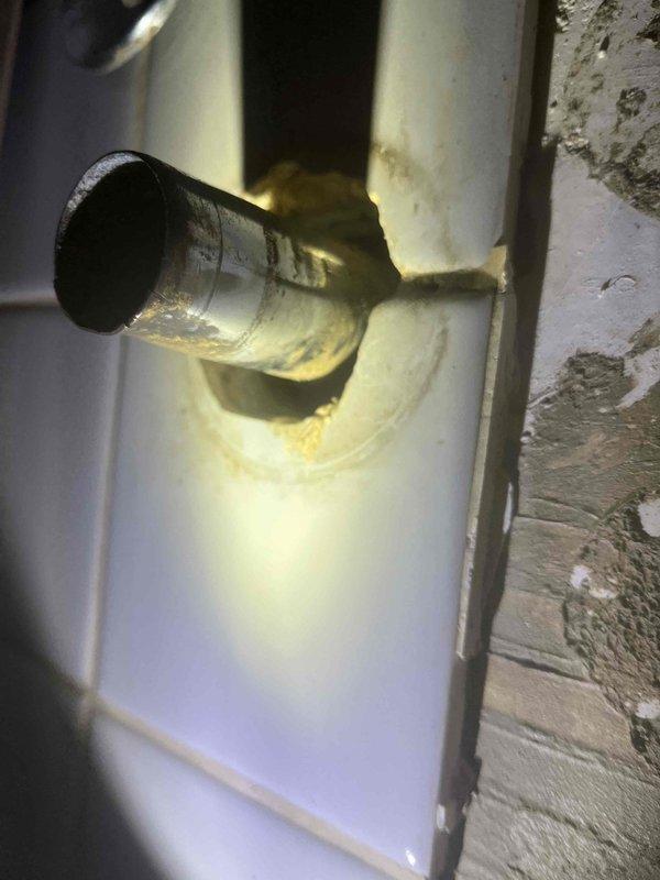 Replaced leaking P-trap in upstairs bathroom. Identified corrosion and water damage around pipe connection to wall. Installation completed with new P-trap to resolve the leak issue.