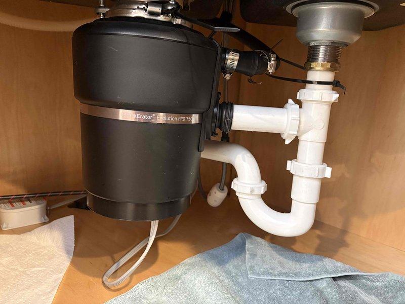Responded to kitchen sink drainage issue at Stephen Yutzy residence. Upon inspection of the InSinkErator Evolution PRO 750 garbage disposal, discovered severely corroded internal spring mechanism causing the blockage. Removed and replaced the damaged component, restoring proper drainage function to the kitchen sink system.