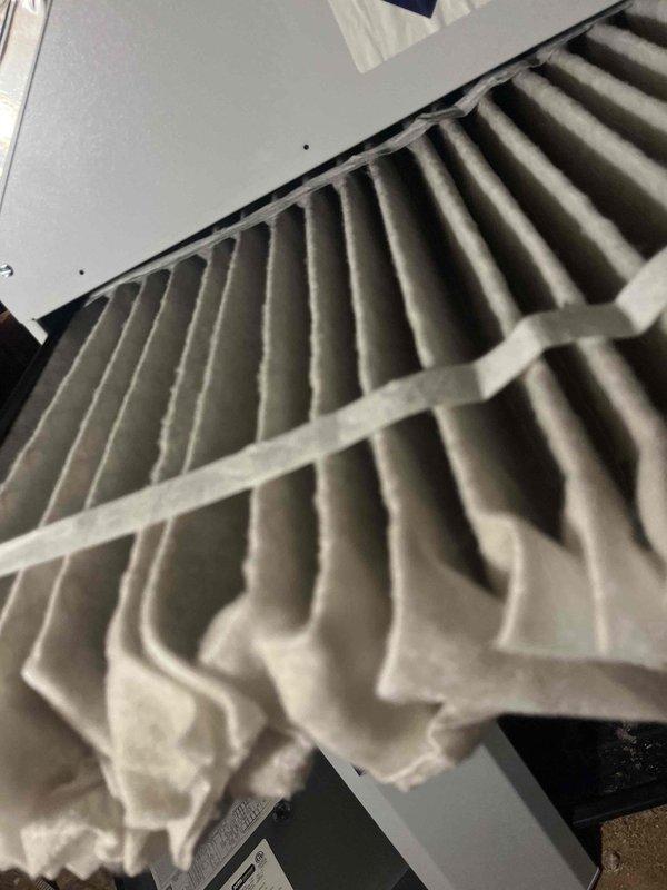 Diagnosed and serviced 3-year-old furnace that was not maintaining set temperature and cycling off prematurely. Inspected air filter which showed significant dust accumulation reducing airflow. Removed and cleaned flame sensor/igniter assembly found in control panel, which was causing improper flame detection and system shutdowns. System now operating correctly and maintaining desired temperature.