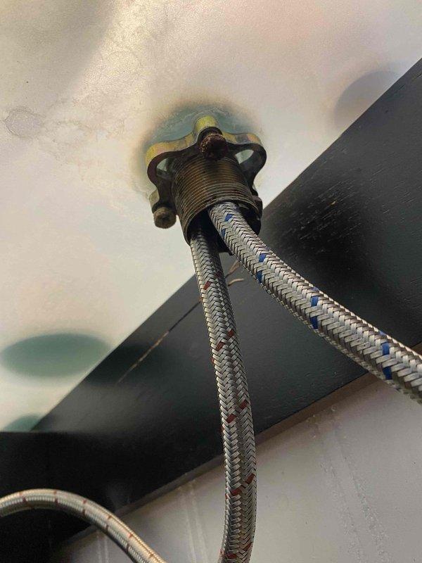 Responded to leak at faucet base. Inspection revealed water seepage around the supply line connection with visible staining on surrounding surface. Replaced corroded brass fitting and installed new braided supply line with proper sealing to resolve the leak.
