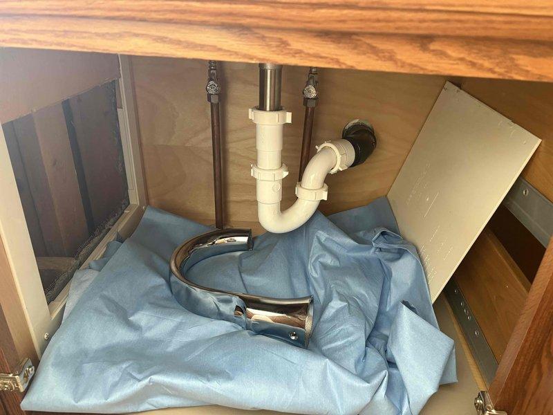 Responded to customer report of water damage on kitchen ceiling below bathtub. Inspection revealed leaking drain assembly under bathroom sink. Removed and replaced faulty P-trap connection and damaged threaded cap. Verified proper drainage and absence of leaks after repair. Advised customer to monitor kitchen ceiling for complete drying.