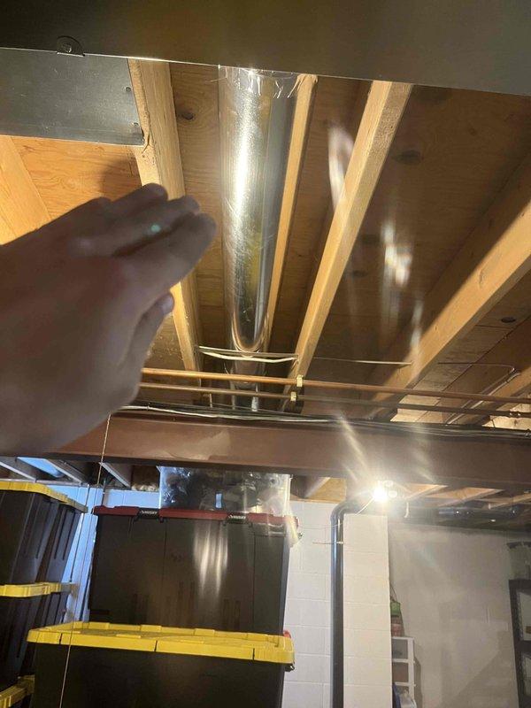 Installed a 6" ductwork run from basement to living room through closet, connecting to a newly installed wall register. Extended and upgraded the duct size to 7" as per previous consultation, enhancing airflow to the entertainment area.