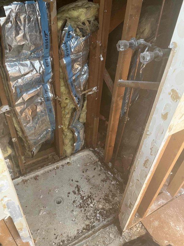 Responded to service call for bathroom pipe leak that had been ongoing for approximately one year. Upon inspection, found significant water damage to subfloor around shower drain with evidence of moisture penetration causing wood warping and possible mold formation. Repaired burst bathroom pipe, inspected surrounding PVC supply lines, and ensured proper sealing of the vapor barrier to prevent future moisture issues.