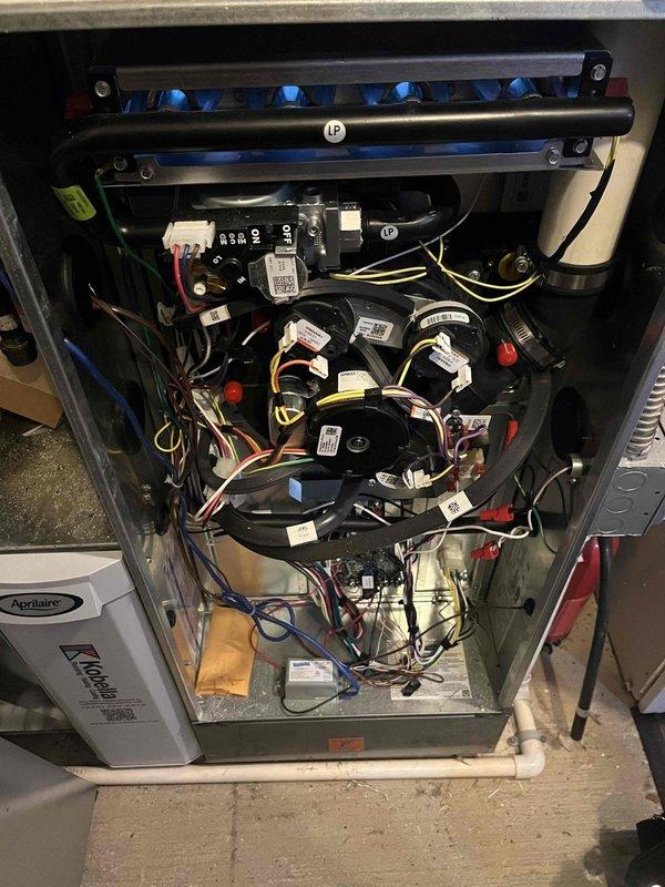 Responded to service call for Bryant system not reaching setpoint temperature (68°F showing only 60°F). Inspected thermostat control and accessed furnace interior for diagnostic evaluation. Observed Aprilaire unit with proper flame pattern in burner assembly. System was operational but underperforming. Contacted dispatch (Laureen) for follow-up scheduling to address temperature differential issue.