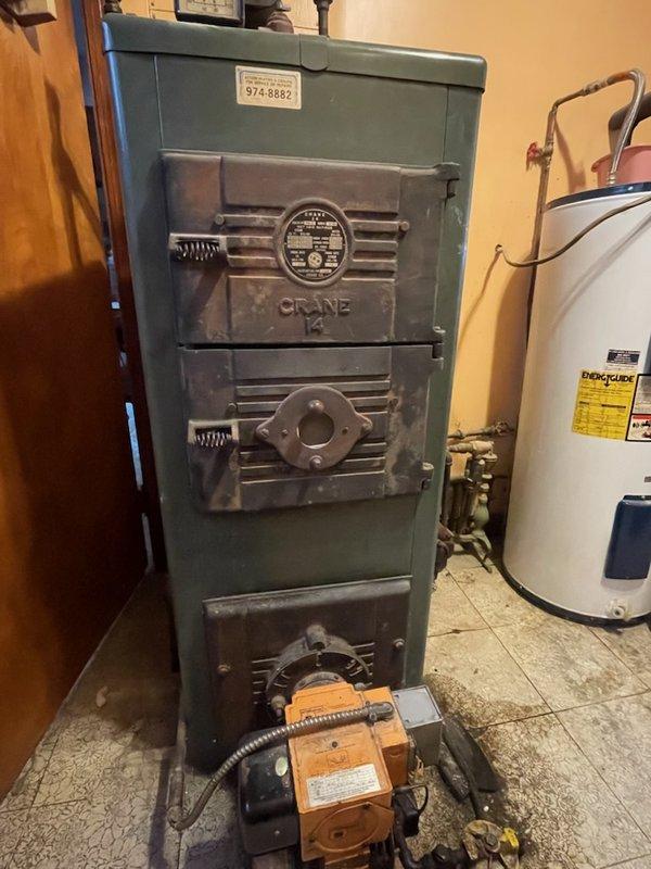 Responded to no heat complaint in residence with indoor temperature at 48°F. Diagnosed failure of circulator pump on aging Crane oil boiler system. Replaced defective 65W circulator pump, purged air from system, and verified proper operation of heating system with multiple zone functionality restored.