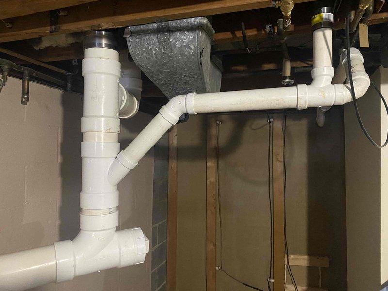Completed installation of new sanitary stack repipe as previously sold. Work involved accessing plumbing through bathroom wall adjacent to toilet and installing new PVC drainage system in basement area with proper joints and connections to existing plumbing infrastructure. All vertical and horizontal sections were properly secured to structural framing.