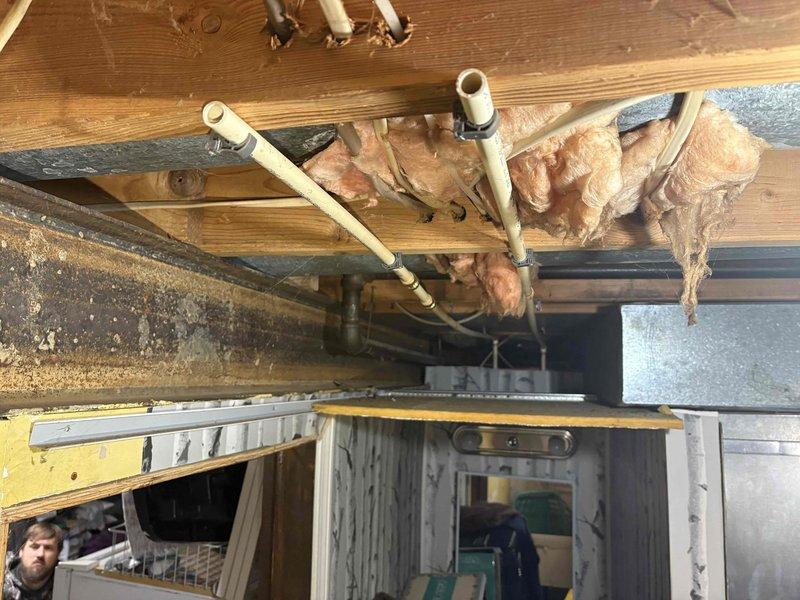 Completed tanked water heater installation of a 50-gallon unit with expansion tank and drain pan. Removed toilet and flange from concrete floor, capped drain hole, and capped water lines for both vanity and toilet. Installed 4" Fernco cap above grade as specified.