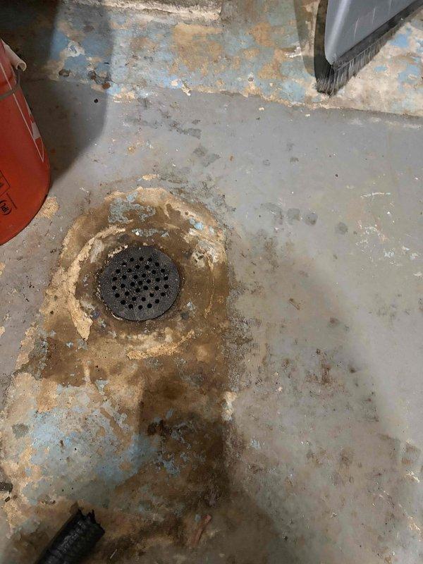 Completed tanked water heater installation of a 50-gallon unit with expansion tank and drain pan. Removed toilet and flange from concrete floor, capped drain hole, and capped water lines for both vanity and toilet. Installed 4" Fernco cap above grade as specified.