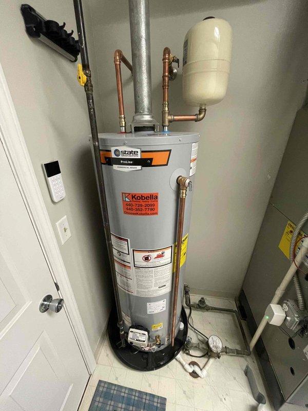 Responded to customer complaint of whistling noise from a State water heater installed in October. Inspected unit and found system pressure at approximately 75 psi, which exceeds normal operating range. Adjusted pressure regulator to bring system pressure within manufacturer specifications, eliminating the whistling noise from the expansion tank and water heater assembly.