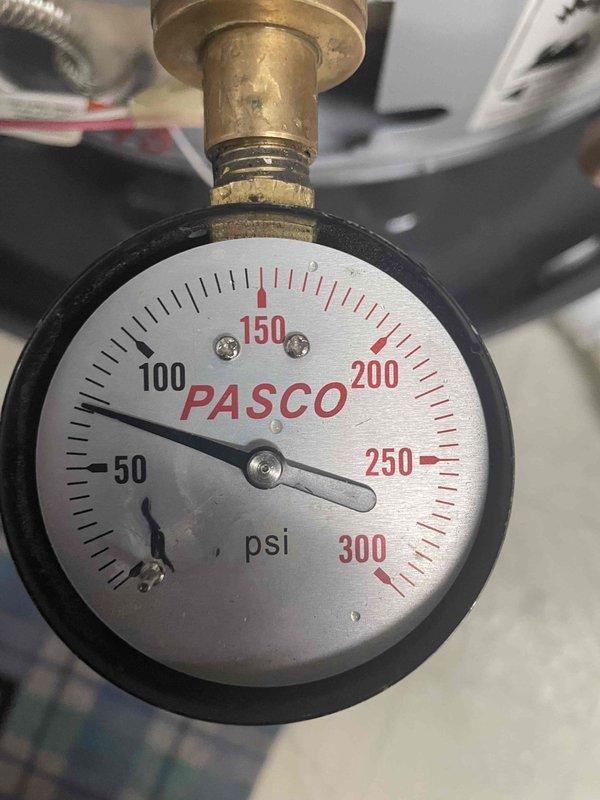 Responded to customer complaint of whistling noise from a State water heater installed in October. Inspected unit and found system pressure at approximately 75 psi, which exceeds normal operating range. Adjusted pressure regulator to bring system pressure within manufacturer specifications, eliminating the whistling noise from the expansion tank and water heater assembly.