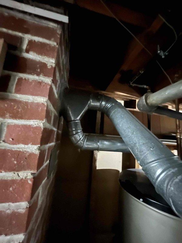 Completed inspection of residential HVAC system to diagnose uneven heating issues throughout home. Examined basement mechanical room containing furnace/air handler with connected ductwork system and photographed existing installation including brick wall area and galvanized metal ducts. Recommended mini-split system installation as solution to address temperature inconsistencies.