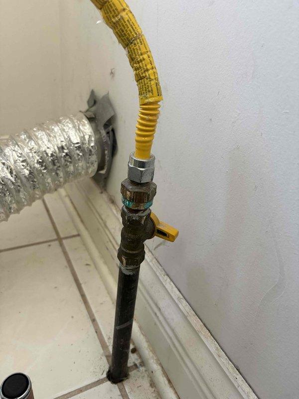Installed new flexible yellow gas line with proper brass fittings to supply gas to customer's dryer. Connected line from existing black pipe with valve to the appliance, ensuring secure connections and proper routing through the utility area.