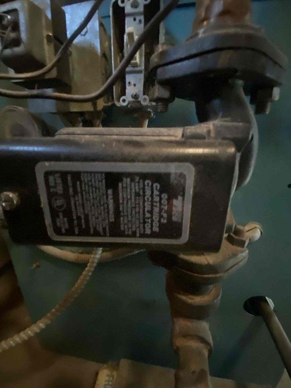Serviced residential baseboard heating system following a lead from Chris D. Inspected the boiler unit and associated radiator components, documenting the existing installation with photographs. Verified proper connection of copper supply lines to the baseboard heater and confirmed system functionality after service completion.