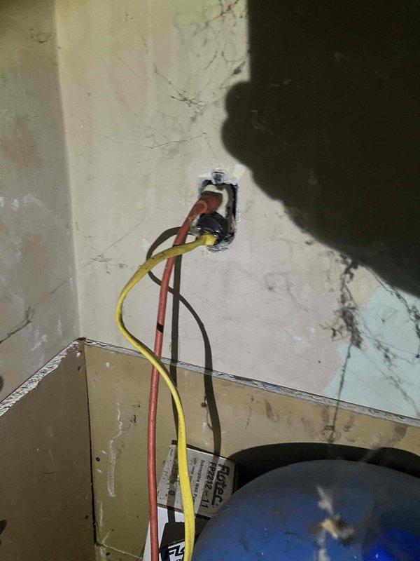 Conducted inspection of client's non-functional water treatment system. Observed electrical issues including exposed wiring at wall outlet with visible damage to surrounding drywall. Evaluated installation area in workshop/garage which contains adequate space for new system replacement. Provided estimate for complete water treatment system replacement.